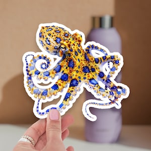 May include: A blue and yellow octopus sticker with a detailed design. The octopus has a spotted pattern and blue eyes.