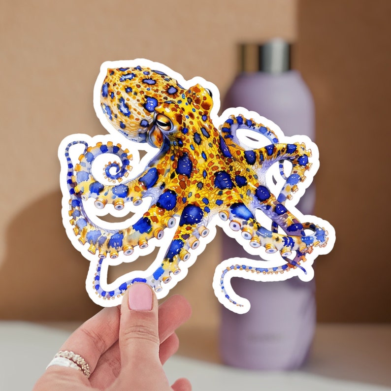 May include: A blue and yellow octopus sticker with a detailed design. The octopus has a spotted pattern and blue eyes.