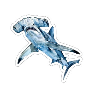 May include: A watercolor painting of a hammerhead shark with a blue and gray color scheme. The shark is swimming with its mouth open, showing its teeth.