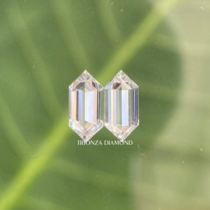 May include: Two clear, octagon-shaped diamonds, side by side, on a green background. The text "TRIONZA DIAMOND" is below the diamonds.