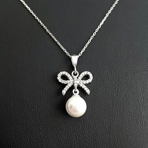 Sterling Silver Pearl Bow Necklace: Elegant Ribbon Pendant