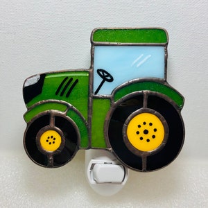 May include: Green and yellow stained glass tractor night light with a white plug-in base.