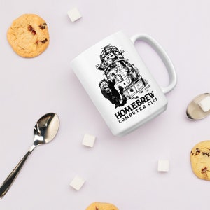 May include: White ceramic mug with a black and white illustration of a computer and the text "Homebrew Computer Club".