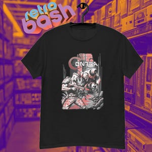 May include: Black t-shirt with a graphic of two characters from the video game Contra. The characters are in a city setting with the word "Contra" in large letters above them.