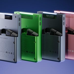 Peut inclure: Quatre appareils m&eacute;talliques argent&eacute;s, verts, noirs et or rose, chacun avec un design rectangulaire et une lumi&egrave;re sup&eacute;rieure. Le texte "BRICK HAMMER" est visible sur chaque appareil. Les appareils ont un compartiment qui s'ouvre pour r&eacute;v&eacute;ler un composant noir.