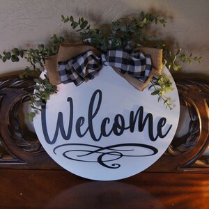Welcome guests to your home with this beautiful door hanger