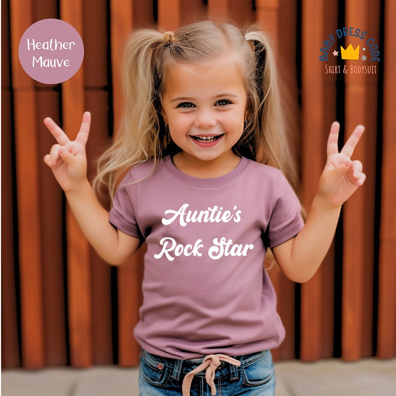 a little girl wearing a t - shirt that says annie's rock star