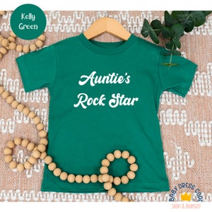 a green t - shirt with the words auntie's rock star on it