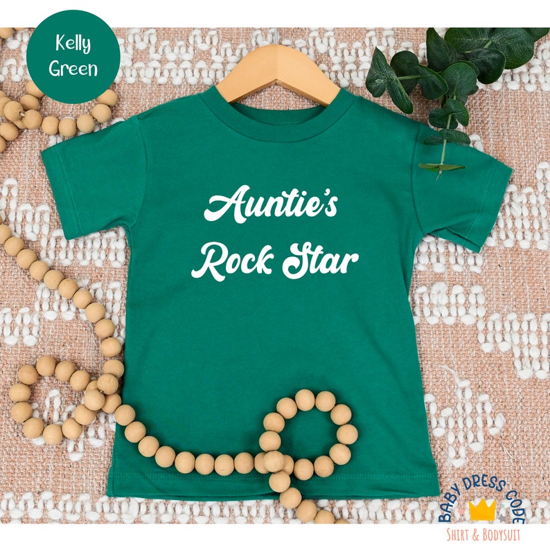 a green t - shirt with the words auntie's rock star on it