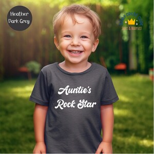 a little boy that is standing in the grass