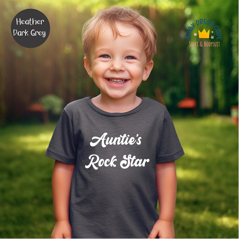 a little boy that is standing in the grass