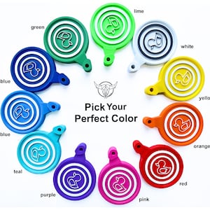 May include: A colorful display of ten round, plastic, duck-shaped keychains in various colors, including blue, light blue, teal, purple, pink, red, orange, yellow, white, and green. The keychains are arranged in a circle with the text "Pick Your Perfect Color" in the center.