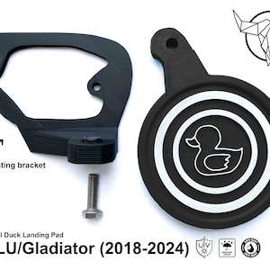 May include: Black plastic duck landing pad with a white duck silhouette inside a circle. The pad is designed to fit Jeep JL, JLU, and Gladiator models from 2018 to 2024. The image also shows a black plastic mounting bracket and a silver screw.