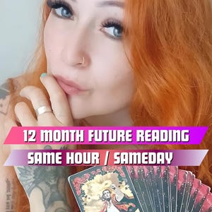 May include: A woman with long, bright orange hair holds a deck of tarot cards. The top card is face up and shows a man in a colorful outfit. The text on the card reads "12 Month Future Reading Same Hour / Same Day".
