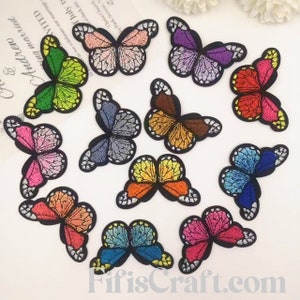 May include: Assortment of 10 colorful embroidered butterfly iron-on patches. The patches are in various colors, including pink, purple, blue, green, orange, and red.