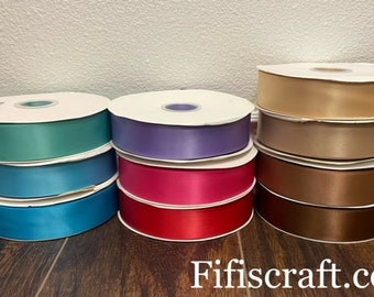 May include: Assortment of eight spools of satin ribbon in various colors, including teal, blue, purple, pink, beige, brown, and gold. The spools are arranged in two rows of four, with the brand name "Fifiscraft.com" visible at the bottom of the image.