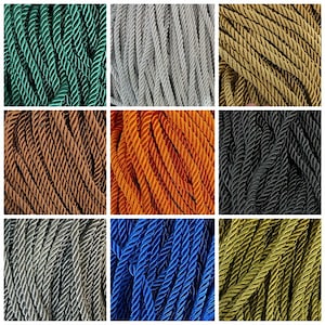 May include: Assortment of nine spools of twisted cord in various colors, including green, gray, gold, brown, orange, black, silver, blue, and olive.