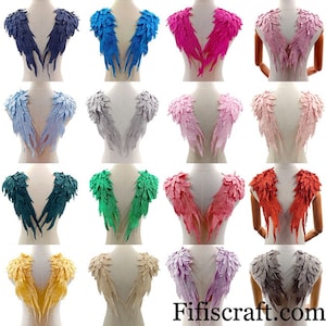 May include: A set of 12 pairs of angel wings in various colors, including blue, pink, gray, green, red, yellow, beige, and purple. The wings are made of lace and have a delicate, feminine look. They are perfect for adding a touch of whimsy to any project.