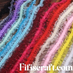 May include: Assortment of colorful ruffled trim in various colors including yellow, pink, white, red, blue, and purple. The trim is made of a soft, sheer fabric and is perfect for adding a touch of elegance to any project.