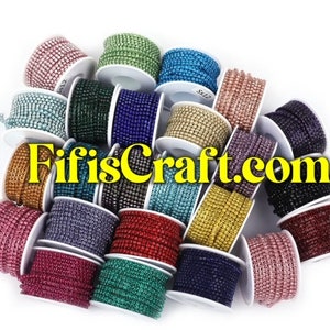 May include: Assortment of spools of rhinestone trim in various colors, including silver, gold, blue, red, green, and pink. The spools are arranged in a circle on a white background. The text "FifisCraft.com" is visible in the center of the image.
