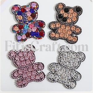 May include: Four rhinestone-covered teddy bear appliques in different colors: multi-colored, brown, pink, and silver.