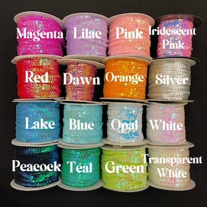 May include: Assortment of 12 spools of iridescent sequin trim in various colors, including magenta, lilac, pink, red, dawn, orange, silver, lake, blue, opal, white, peacock, teal, and green.