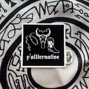 May include: Black and white sticker with a bull skull, barbed wire, and a cowboy boot. The text "y'allternative" is below the image. The sticker has an "Easy Peel" label.
