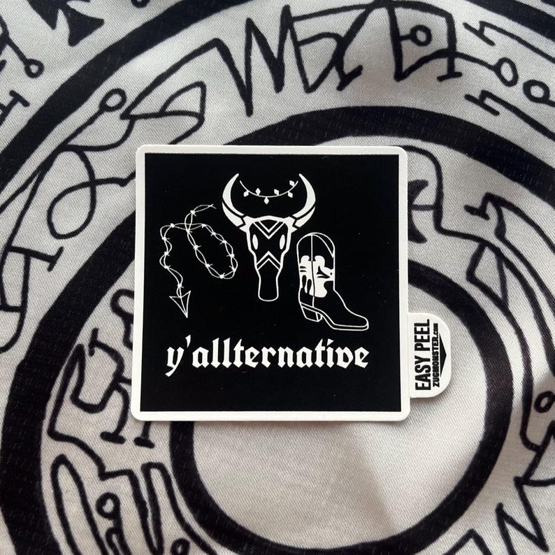 May include: Black and white sticker with a bull skull, barbed wire, and a cowboy boot. The text "y'allternative" is below the image. The sticker has an "Easy Peel" label.