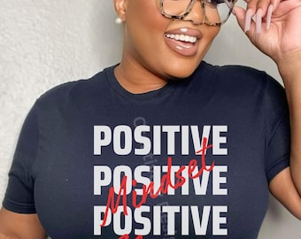 May include: A black t-shirt with white text that reads "POSITIVE Mindset POSITIVE Always" in red lettering.