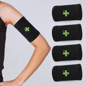May include: Set of four black arm bands with a green plus sign and a blue dot on each. The arm bands are made of a soft, stretchy material and are designed to be worn on the upper arm.