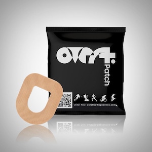 May include: A brown, donut-shaped adhesive patch with a hole in the center. The patch is packaged in a black pouch with the text "over7+ patch" and a QR code. The pouch also features icons of people participating in various sports, including skiing, hiking, running, cycling, and snowboarding. The text "Order Now - curativediagnostics.com" is printed below the icons.
