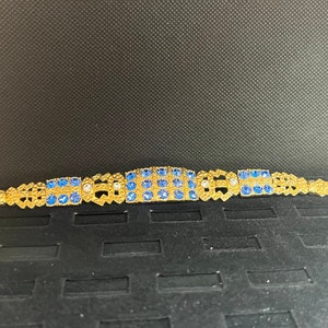 Camrose & Kross, Jacqueline Kennedy Collection Gold bracelet with blue and clear imitation gemstones