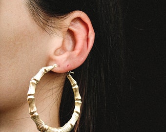 thumbnail interactive-video image 1 of 10K Yellow Gold 75mm Bamboo Hoop Earrings – Graduated Diamond Cut, Huge Size 1 of 2