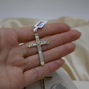 Puede incluir: Un colgante de cruz de oro con diamantes de talla baguette. La cruz est&aacute; engastada con diamantes en ambos lados y tiene un acabado pulido.