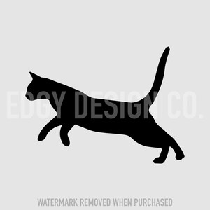 May include: Black silhouette of a cat jumping in mid-air with its tail raised.