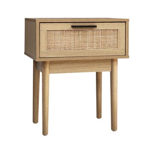 May include: A light wood bedside table with a single drawer featuring a woven rattan front. The drawer has a black handle and the bedside table has four legs.
