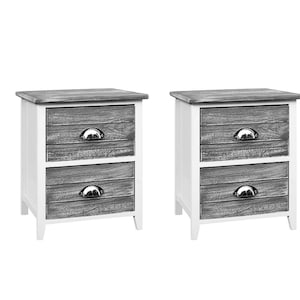 May include: A pair of bedside tables. Each has a white frame, grey wooden drawer fronts, and a grey top. The drawers have silver-coloured, half-moon handles. Each table has two drawers and stands on short, white legs. The dimensions are approximately 50cm high.