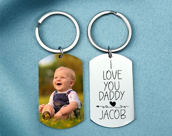 May include: Silver keyring with two tags. One tag has a photo of a baby boy and the other tag says "I love you Daddy Jacob" with an arrow and heart.
