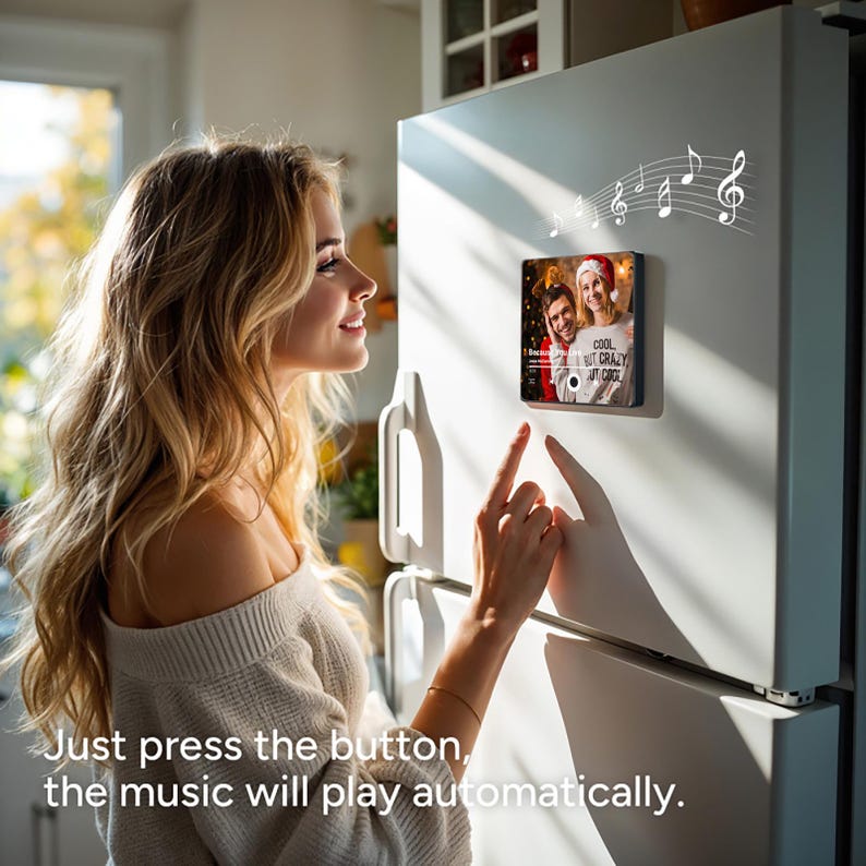 May include: A woman presses a button on a photo frame with a picture of three people. The frame is attached to a white refrigerator. Music notes are visible above the frame. The text on the frame reads "Cool but Crazy at Once".