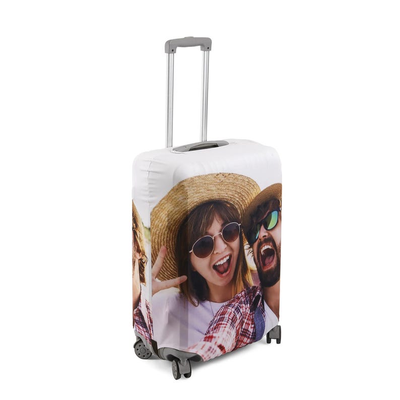 May include: A white suitcase cover with a photo of three people smiling and wearing sunglasses. The people are wearing casual clothing and hats. The suitcase cover has a zipper closure and a handle.