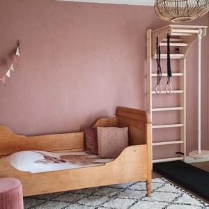 BenchK wall bars with an adjustable pull-up bar, a removable BenchTop used as a desk and gymnastic accessories