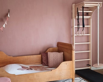 BenchK wall bars with an adjustable pull-up bar, a removable BenchTop used as a desk and gymnastic accessories
