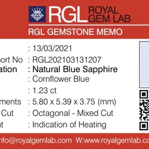 May include: A gemstone memo from Royal Gem Lab. The memo details a natural blue sapphire with a cornflower blue color. The gemstone weighs 1.23 ct and measures 5.80 x 5.39 x 3.75 mm. The shape is octagonal with a mixed cut.