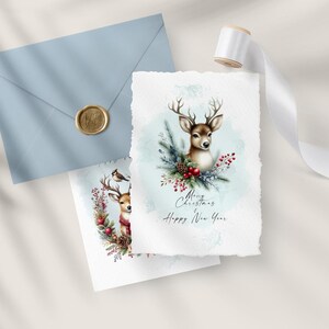 May include: Two watercolor Christmas cards featuring a deer with a wreath of holly and berries. The card on the left has a small bird perched on the wreath. The card on the right has a larger deer with the text "Merry Christmas Happy New Year".