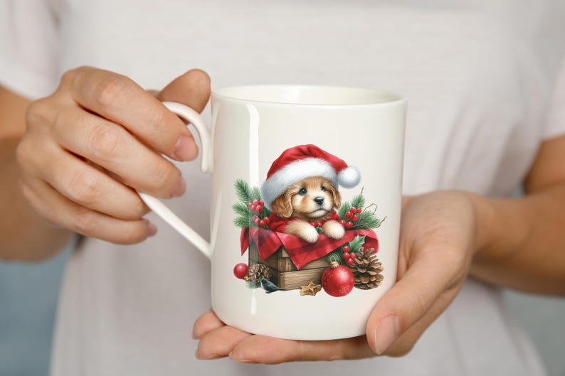 May include: White ceramic mug featuring a festive illustration of a puppy wearing a Santa hat, nestled in a wooden box with red plaid fabric. The design includes pine needles, red berries, and ornaments, perfect for the holiday season.