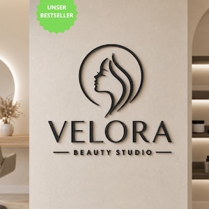 Könnte beinhalten: Ein schwarzes 3D-Wandschild mit dem stilisierten Profil eines Frauengesichts in einem Kreis über dem Schriftzug VELORA BEAUTY STUDIO. Ein hellgrünes sternförmiges Abzeichen in der oberen linken Ecke zeigt den Text UNSER BESTSELLER in Weiß.