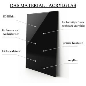 May include: A black acrylic sheet with the text "DAS MATERIAL - ACRYLGLAS" at the top. The sheet is 3mm thick and has a high gloss finish. It is lightweight and recyclable. The text "3D Effekt", "f&uuml;r Innen- und Au&szlig;enbereich", "leichtes Material", "hochwertiges 3mm hochglanz Acrylglas", "pr&auml;zise Konturen", and "recylbar" are written around the sheet.