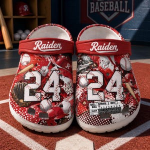 May include: Pair of red and white baseball-themed clogs with the name "Raiden" on the strap. The clogs feature baseball graphics, the number "24", and a baseball score chart. The background includes baseball equipment.