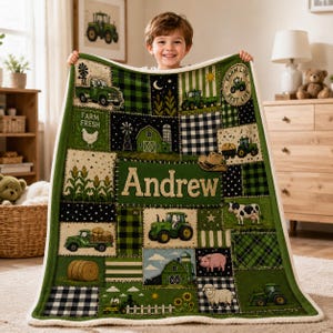 May include: A rectangular plush throw blanket featuring a patchwork design with green, black, and white farm-themed illustrations including tractors, barns, farm animals, and the name Andrew printed in large beige letters across the centre.