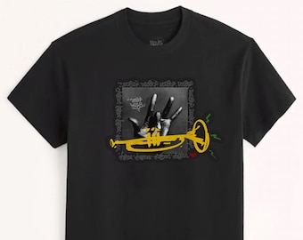 May include: A black short-sleeved t-shirt featuring a graphic print of a hand making a sign, a yellow trumpet illustration, and the repeated text "DOOBOP" in a square frame. The design includes small green lines and a red accent mark.